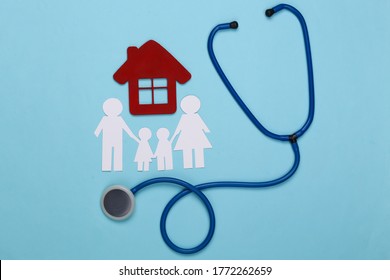 Stethoscope And Paper Chain Family, House On Blue Background, Health Insurance Concept