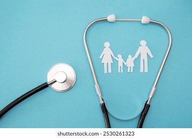 Stethoscope with paper cutout family on blue background , family healthcare concept - Powered by Shutterstock