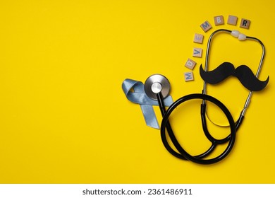 Stethoscope with paper mustache and blue ribbon, Movember concept - Powered by Shutterstock