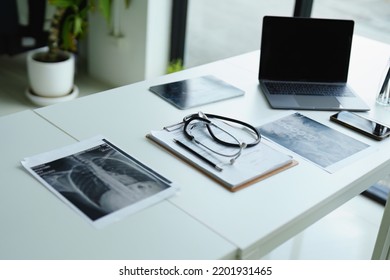 Stethoscope, Patient X Ray Film, Important Documents And Computer On Doctor's Desk.