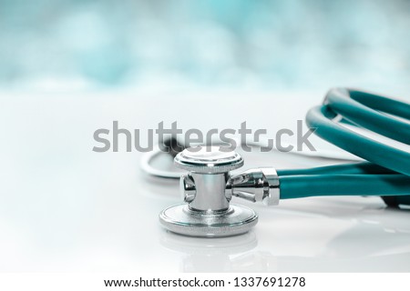 Stethoscope or phonendoscope on a doctor's white desk on cloudy morning. Treatment of cold or flu.