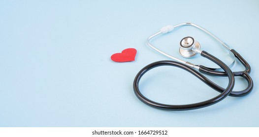 Stethoscope and red heart on a blue background. Greeting background. National doctor's day. Happy nurse 's day. Health day. Top view, a copy of the space. Thank you doctors and nurses .