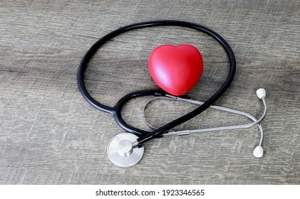 Stethoscope And Red Heart On Old Wooden Table Background. Healthcare Concept.