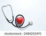 Stethoscope with red heart on white background, top view