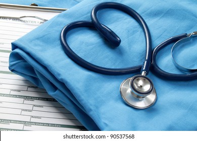 A stethoscope shaping a heart and a clipboard on a medical uniform, closeup - Shutterstock ID 90537568