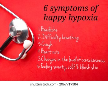 Stethoscope With Text 6 Symptoms Of Happy Hypoxia  On A Red Background. Healthcare Concept.