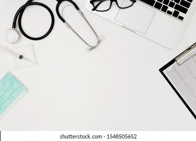 Stethoscope, Top View Of Doctor's Desk Table, Blank Paper On White Background, Above View Doctor Work Tools On White, Stethoscope, Laptop, Eyeglass And Medical Drug On White Background, Medical Doctor