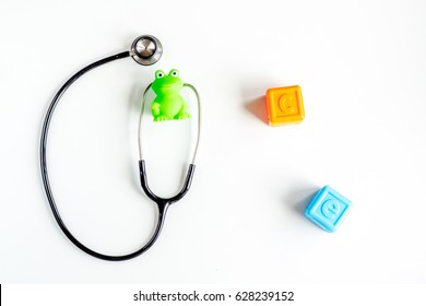 Stethoscope, Toys On Children's Doctor Office Desk Background Top View Mockup