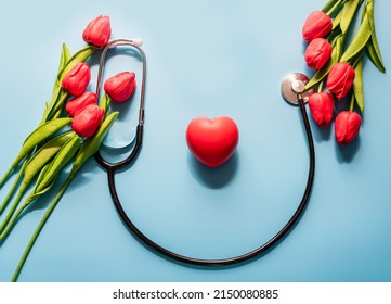 Stethoscope, Tulips, On Blue Background. Greeting Background. Happy Nurse's Day. Health Day. National Doctor's Day. Top View, Closeup. Thank You, Doctors And Nurses. Selective Focus