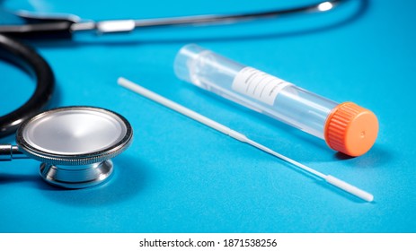 Stethoscope With Viral Transport For PCR In Laboratory Orange Closure, Transparent Liquid, Adhesive For Patient Data, And Swab (obtaining Analysis For Results), With Blue Background