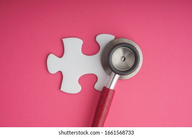 Stethoscope   white jigsaw puzzle pink background  Cancer awareness campaign concept  Copy space