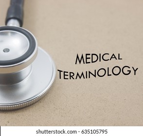 Stethoscope And Word Medical Terminology Isolated Over Yellow Background.medical Concept.
