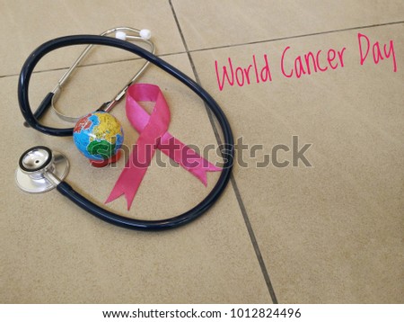 Stethoscopes, globes and pink ribbons from the world cancer day symbol. World Cancer Day concept.