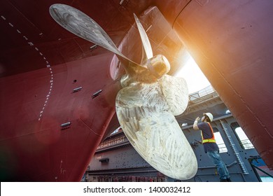 Stevedore, controller, Port Master, surveyor inspect theaft stern propeller of the ship in floating dry dock, recondition of overhaul repairing and painting, sand blasting in dry dock yard