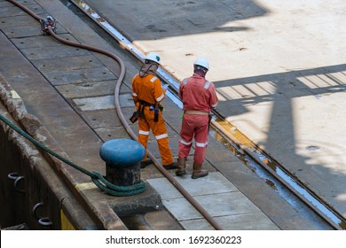 Stevedore Crews Taking Rest During Bunkering Or Refueling Of A Barge At Wharf