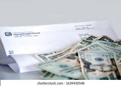 Stevensville MI USA July 7 2014;
An IRS Letter With A Pile Of American Currency Reminds Us All That Tax Time Is Here