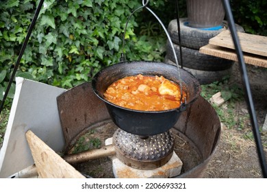 The Stew Food In Big Pot Placed On Outdoor Stove