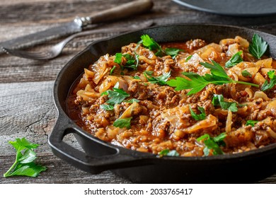 Stew With Minced Meat And Cabbage Served In A Cast Iron Pan On Rustic And Wooden Table