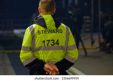 Steward Works At An Event, Back View