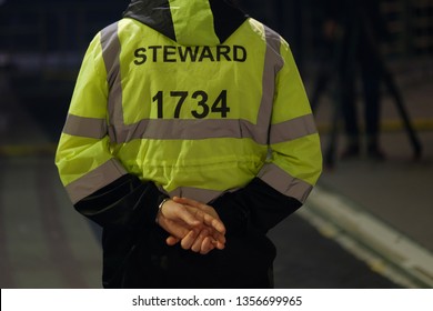 Steward Works At An Event, Back View