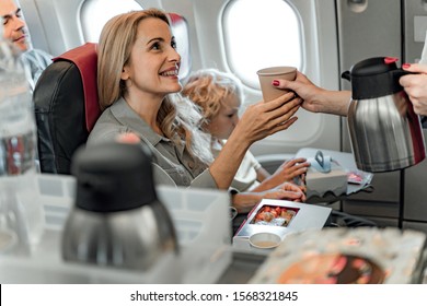 Stewardess Giving Coffee For Happy Lady Stock Photo