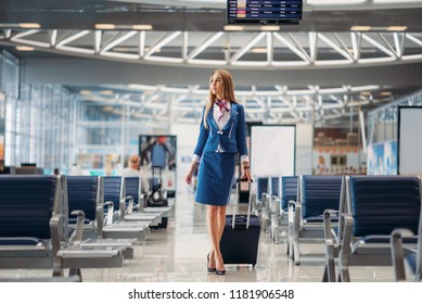 Stewardess With Hand Luggage Going In Airport Hall