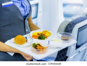 Stewardess Holding Tray With Airplane Food