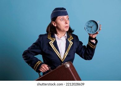 Stewardess Running Late At Airport, Holding Retro Alarm Clock, Carrying Baggage. Airplane Flight Attendant, Overslept, Looking At Time, Air Hostess Hurry Up At Work With Luggage