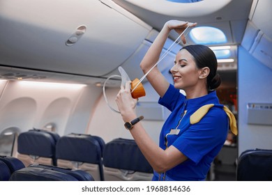 Stewardess Is Showing Safety Rules Before Fly At Evening Plane Salon