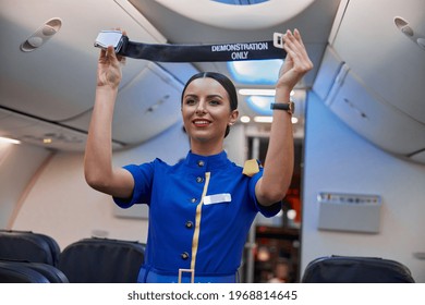 Stewardess Is Showing Safety Rules Before Fly At Evening Plane Salon