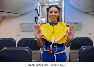 Stewardess Is Showing Safety Rules Before Fly At Evening Plane Salon