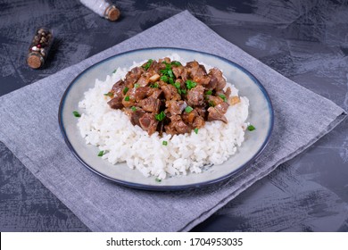 Stewed Chicken Gizzards On The Boiled Rice. Hot Meal With Offal Meat Products