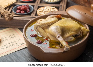 Stewed chicken soup with Chinese herbal medicine.English Translation:Traditional Chinese medicine is used in the prevention and treatment of diseases, has the function of rehabilitation. - Shutterstock ID 2022595001