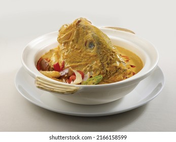 Stewed Fish Head With Curry In Claypot Served In A Dish Isolated On Wooden Board Side View Dark Background