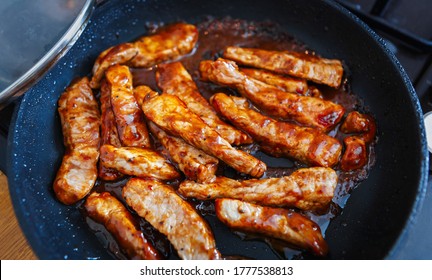 Stewed Pork Meat Strips Cooking On Hot Pan In Home Kitchen For Dinner. Delicious Braised Beef Cooked In Caramel Sauce With Black Pepper And Soy Sauce. Enjoy Spicy Bbq Meal Prepared With Exotic Recipe