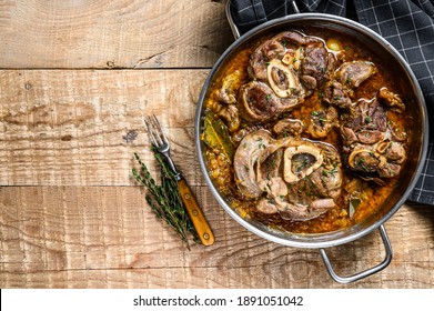 Stewed veal shank meat Osso Buco, italian ossobuco steak. wooden background. Top view. Copy space.