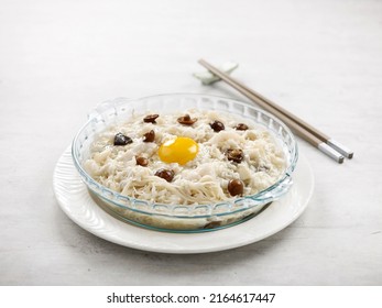 Stewed Vermicelli Topped With Shredded Fish And Conpoy Served In A Dish Side View On Grey Background