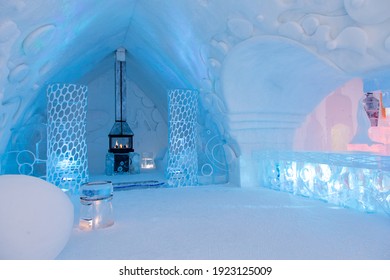 St-Gabriel-de-Valcartier, Quebec, Canada, February 23, 2021 - Lighted fireplace in the world-renowned seasonal Ice Hotel’s spectacular bar illuminated in blue