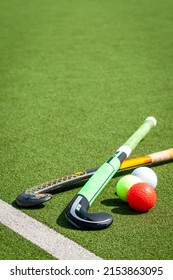 stick and balls for playing field hockey on the grass background - Shutterstock ID 2153863095