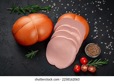 Stick of boiled sausage on a dark background.Doctor's sausage isolated on a white background. Meat boiled sausage