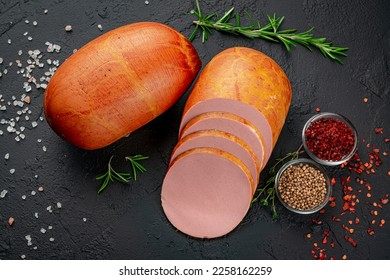 Stick of boiled sausage on a dark background.Doctor's sausage isolated on a white background. Meat boiled sausage