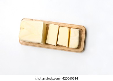 Stick Of Butter Cut Isolated On Wood.