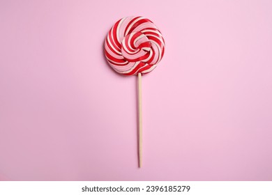 Stick with colorful lollipop swirl on pink background, top view - Powered by Shutterstock
