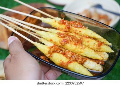 Stick egg with chili sauce by Indonesian street food. Telur gulung dengan sambal pedas. - Shutterstock ID 2233932597