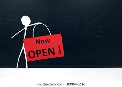 Stick Man Figure Holding A Now Open Red Signage. Business And Shop Opening Concept