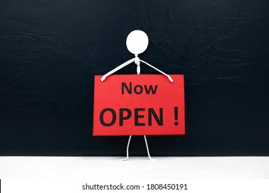 Stick Man Figure Holding A Now Open Red Signage. Business And Shop Opening Concept