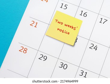 Stick note with handwritten remark and words - Two weeks' notice - on calendar , means employee courtesy to give employer time to prepare for resignation and hiring someone else - Shutterstock ID 2174964999