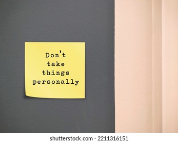 Stick note on wall with text written - Dont Take Things Personally - stop being upset that others are criticizing you in particular, convinced that another person comments are about you  - Shutterstock ID 2211316151