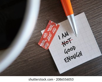 Stick note and pen with text written I AM NOT GOOD ENOUGH, changed to I AM GOOD ENOUGH, concept of overcome negative inner voice and change to positive self talk to boost self esteem - Shutterstock ID 2086556053