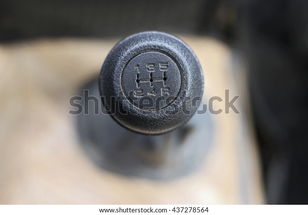 Stick shift with a\
black head inside auto